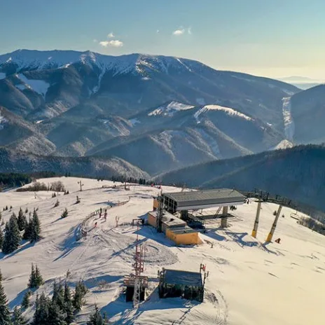 Aerial view of Donovaly ski resort in Slovakia with the Low Tatras rising behind the lift station