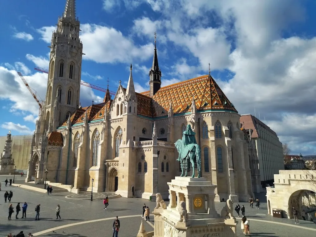 Matthias Church in Budapest with its patterned tiled roof, and the equestrian statue of St Stephen in front of Fisherman's Bastion.