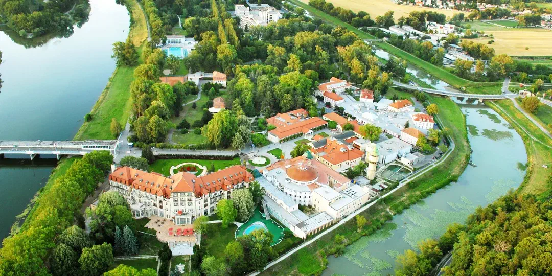 Spa Island in Piešťany from the air, with the Thermia Palace hotel and the domed Irma spa building in the park between the Váh and its side channel.