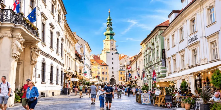 Michael's Gate and the pedestrian street through Bratislava's old town on a summer afternoon.