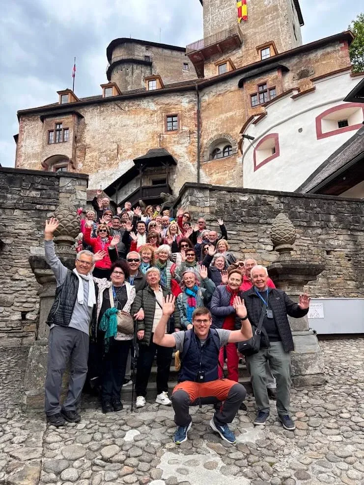 Andrej Stanik with a large, cheering tour group on the steps of Orava Castle.