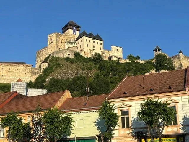 Trenčín Castle on its rock above the pastel houses of the old town.