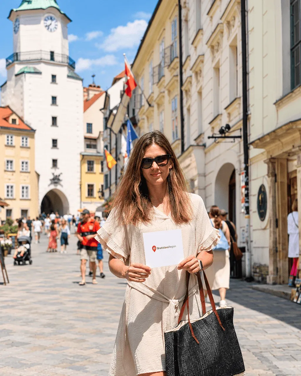 Katarina Stanik, MICE specialist at E-TRAVEL.SK, on Michalská Street in Bratislava’s Old Town, with St Michael’s Gate behind her.