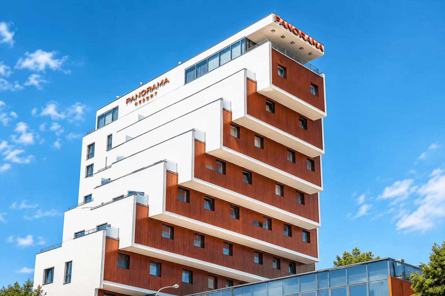 The stepped façade of the Panorama Resort hotel at Štrbské Pleso in the High Tatras, against a blue sky.