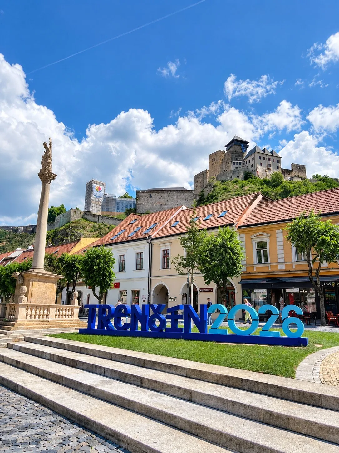 The TRENCIN 2026 sign on the main square below Trencin Castle, Slovakia.