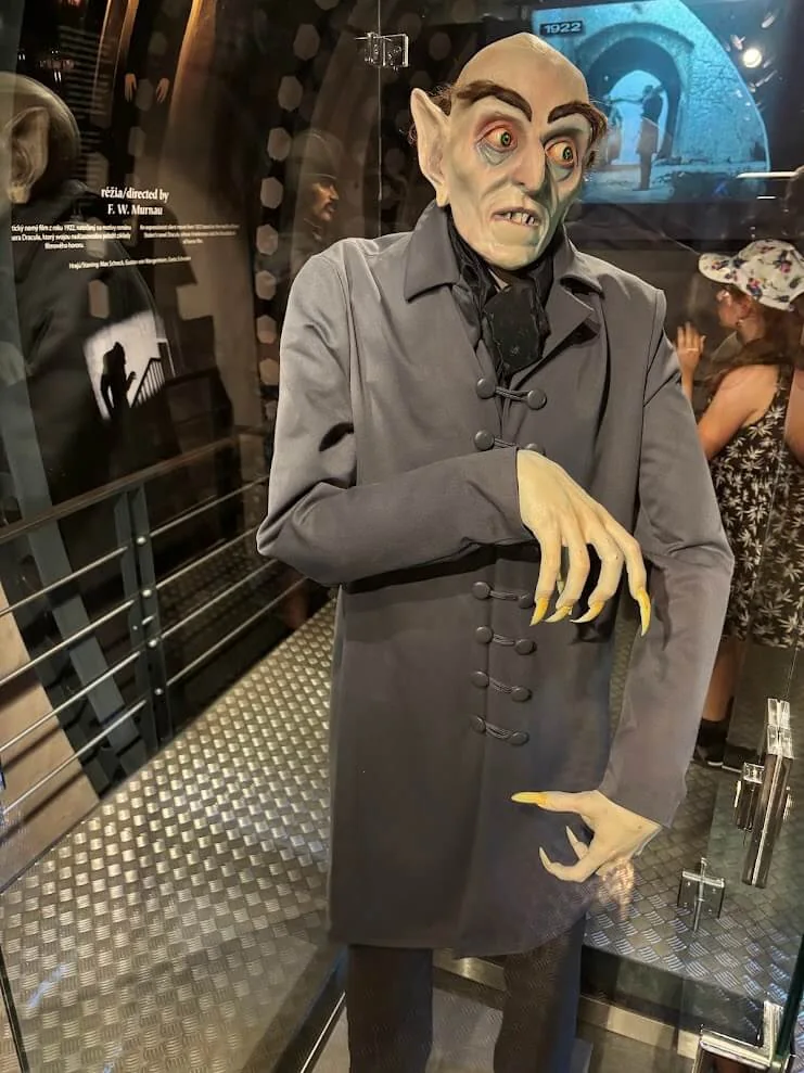 A life-size figure of Count Orlok from F. W. Murnau’s 1922 film Nosferatu, standing in a lit glass case in the castle’s Nosferatu exhibition.